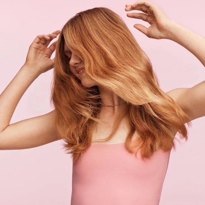 A model showing off their vibrant and healthy red hair.