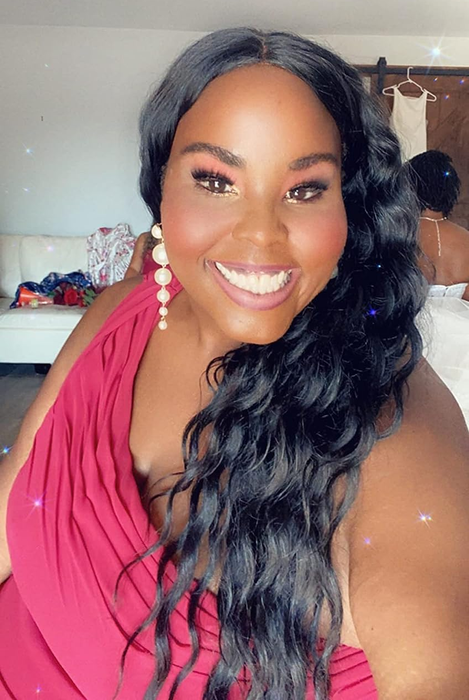 a reviewer sporting pearl drop earrings