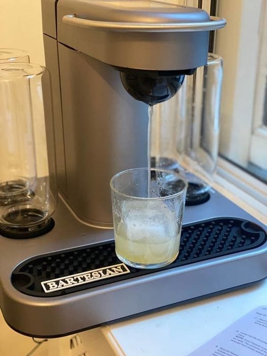 The Bartesian machine pouring a margarita into a lowball glass.