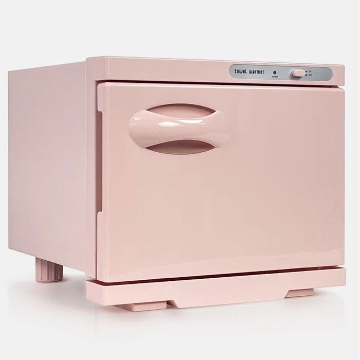 A compact, pink towel warmer featuring a curved handle and a digital control panel positioned on the top-right corner.