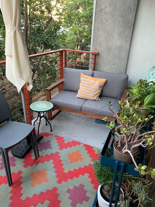 The gray loveseat is shown on a reviewer's balcony