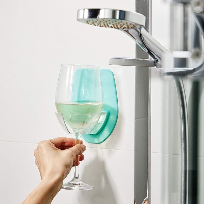 a model placing their wine glass in the shower with the silicone holder