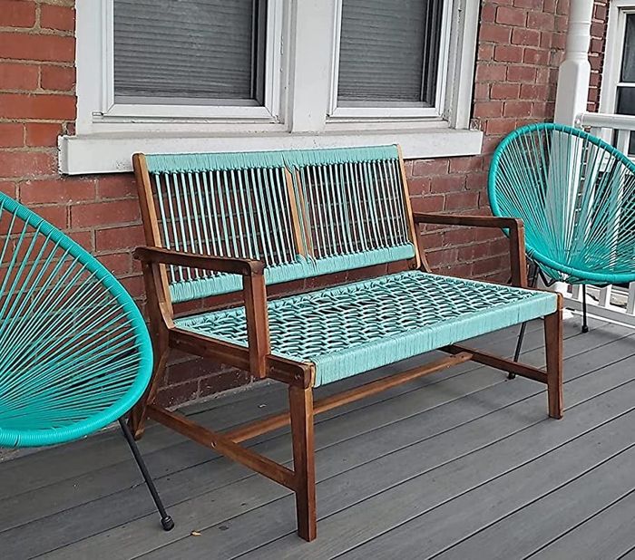 A reviewer's bench with turquoise rope is pictured on a porch