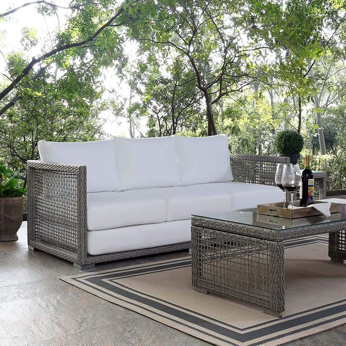 The sofa is displayed on a patio setting