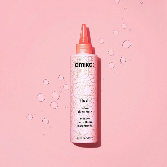 A pink bottle of Amika instant shine mask.