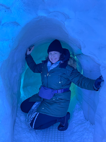Mytour editor Elizabeth Lilly posing in an ice cave with a waist bag on