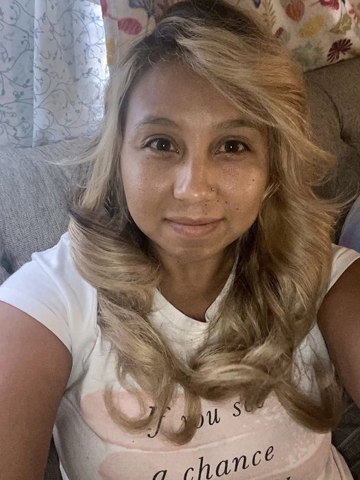 A reviewer’s photo showing their curled, voluminous hair.