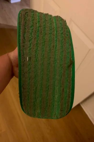 A reviewer's used mop pad, dirty and covered with dust