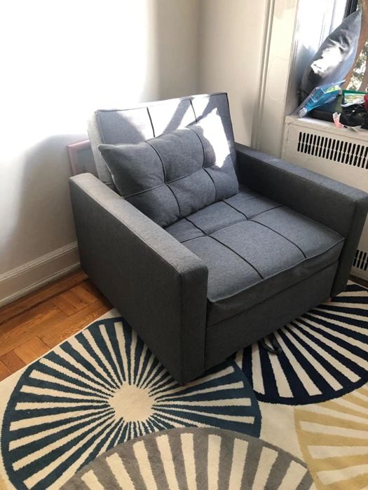 A reviewer's gray chair, complete with a matching pillow.