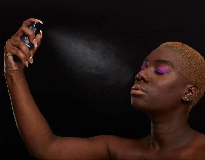 A model spraying the setting mist for a fresh finish