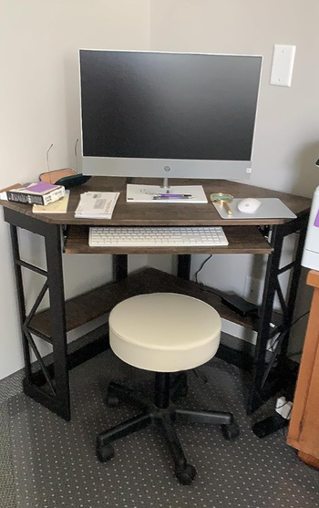 a reviewer's black corner desk
