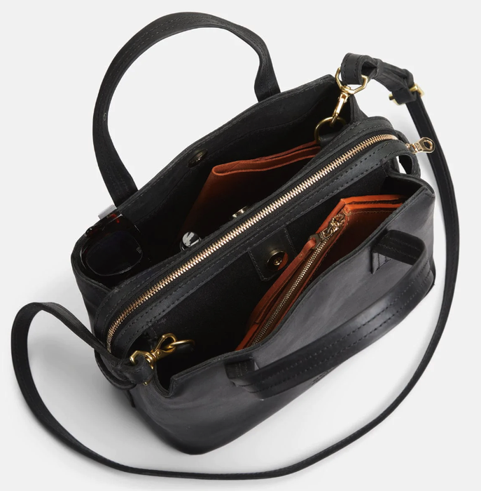 A sleek black leather handbag, ready to complement any outfit.