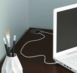 Close-up view of the wire management system on the desk