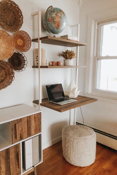 boho-style office with a ladder desk featuring white piping and a wooden shelf mounted on the wall