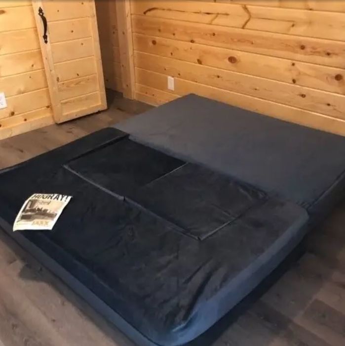 A sleek black velvet open daybed that exudes modern elegance