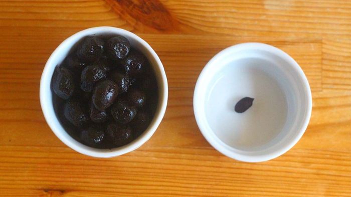 Prompt olive consumption by setting a single pit in a ramekin