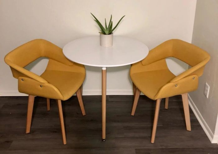 A reviewer's photo showing the yellow upholstered chairs