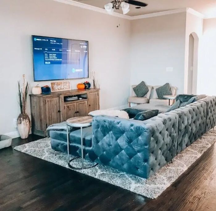 large tufted light teal velvet sectional couch with double seating for extra comfort