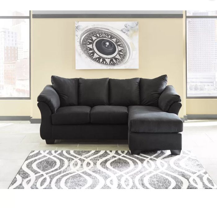 black L-shaped sectional with comfy cushions
