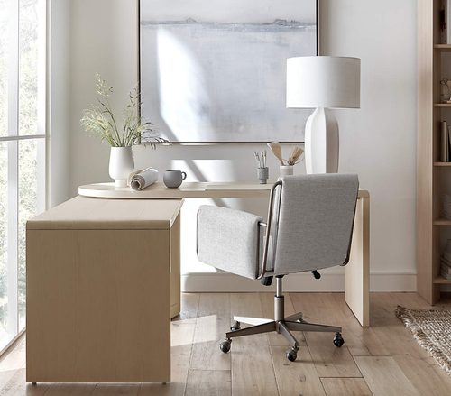 the light wood desk turned to function as a corner desk