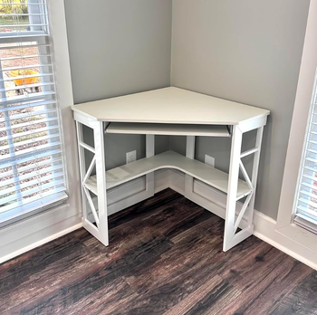 a reviewer's white corner desk