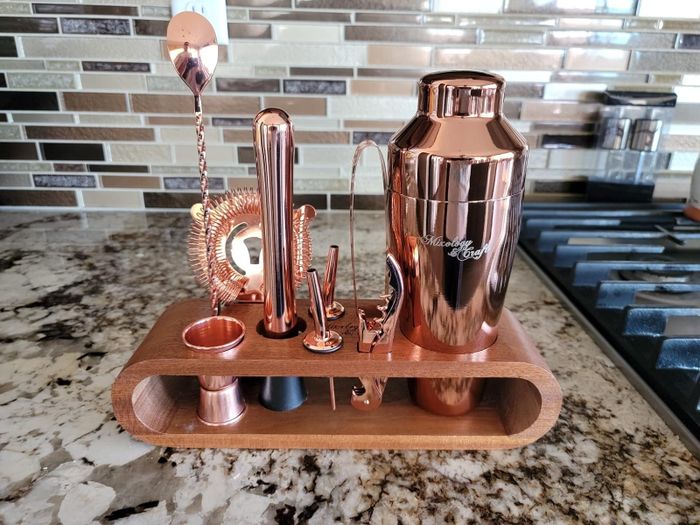 reviewer's copper bartender kit featuring pieces on a stand