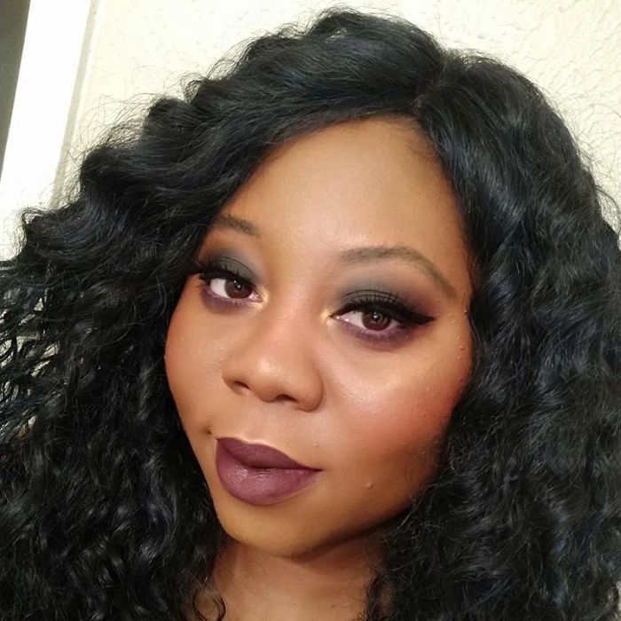 Reviewer rocking a bold dark purple shade