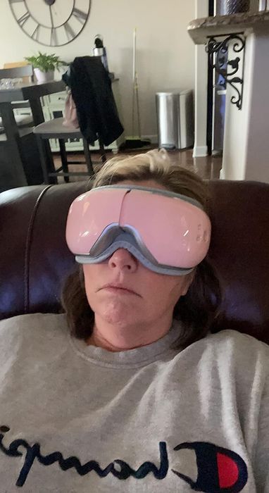 Another reviewer relaxing with the eye mask in place, embracing its calming, therapeutic benefits.