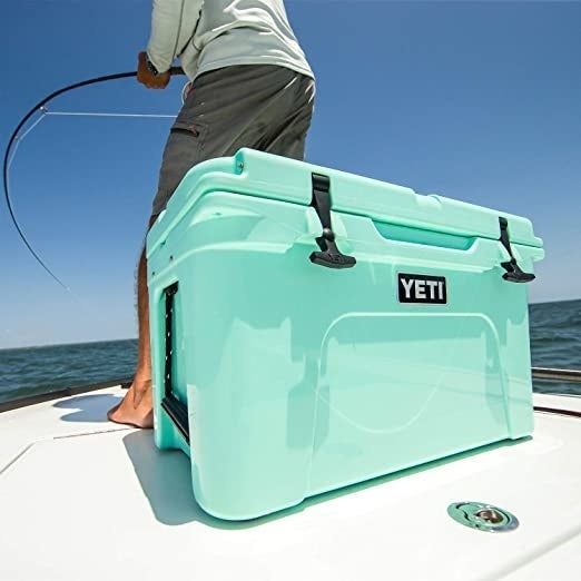 A light blue Yeti cooler resting on a fishing boat, ready for an outdoor adventure.