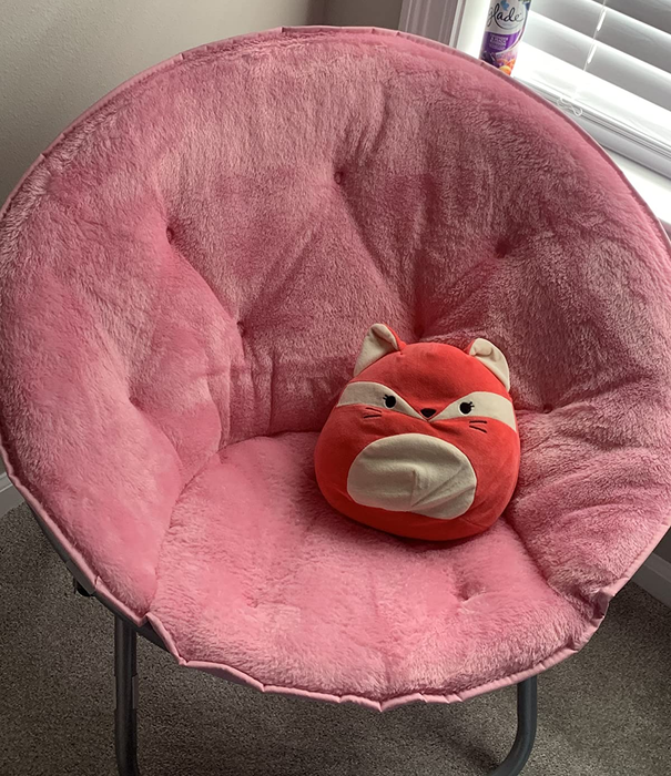 A reviewer image featuring a pink chair with a red fox throw pillow.