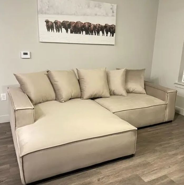 a tan, glossy, oversized sectional sofa