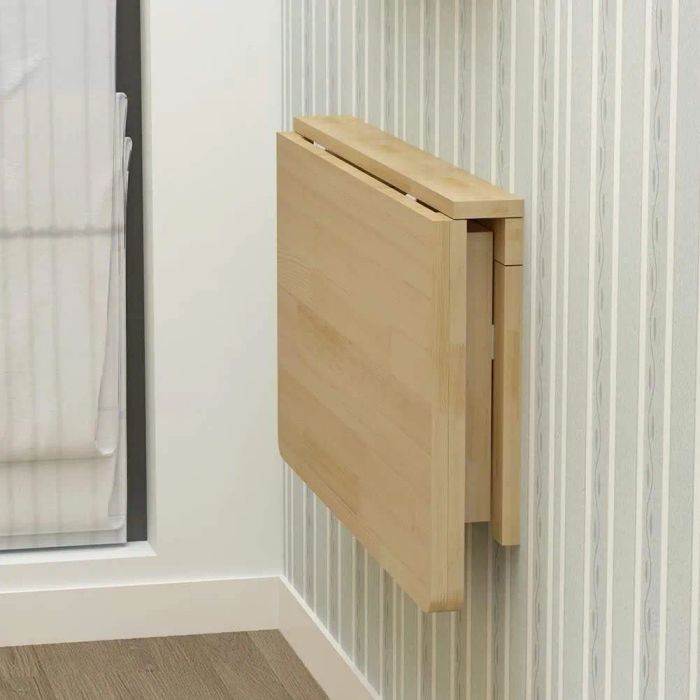 A tan table folded flat against the wall.