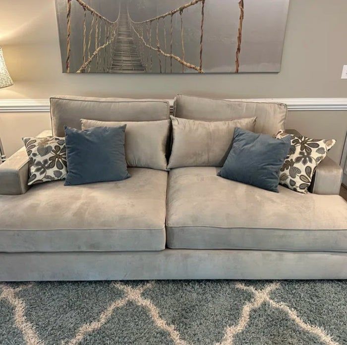 beige/taupe velvet sofa with decorative throw pillows