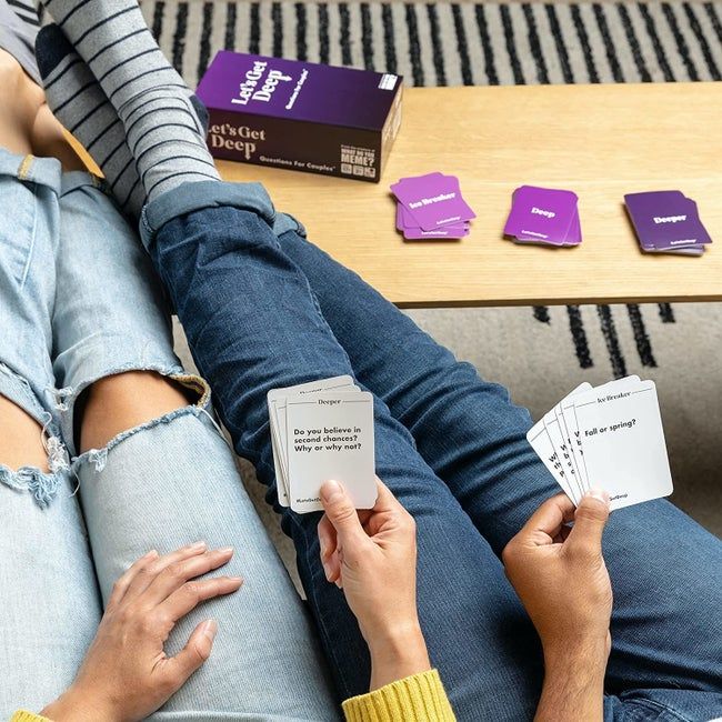 A couple enjoying a fun moment together, flipping through cards from the 