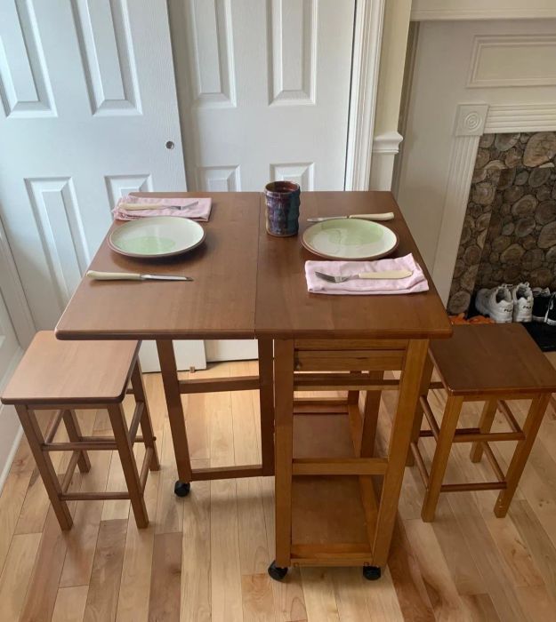 The same reviewer's table with the leaf extended and stools in use.