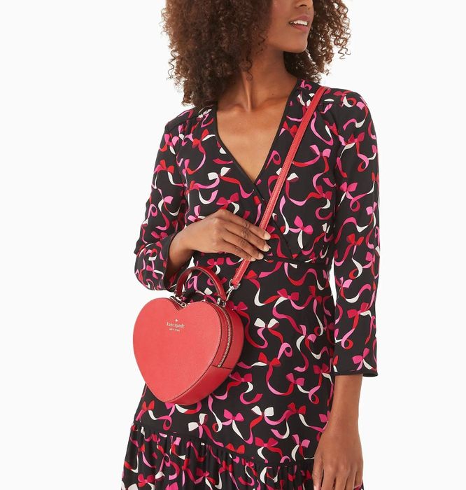 A model rocking a red heart-shaped crossbody bag