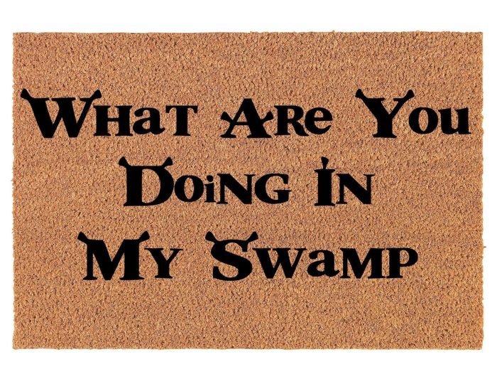 A tan doormat with black lettering that reads, 