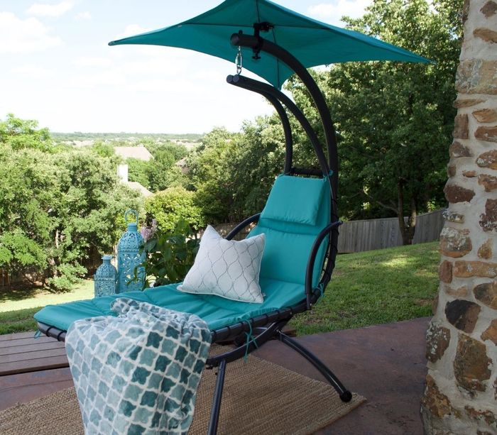 A different reviewer enjoying their blue swing in the backyard.