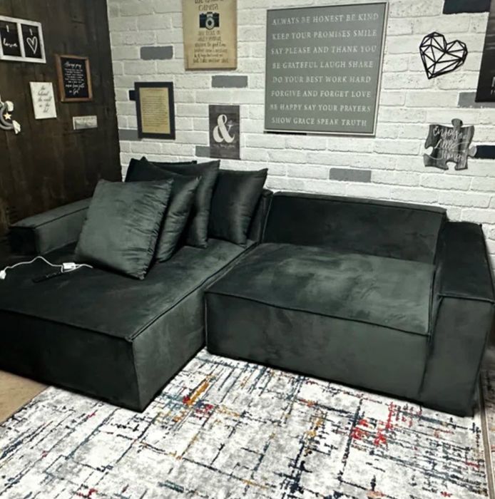 spacious dark grey velvet sectional with matching pillows in a square design