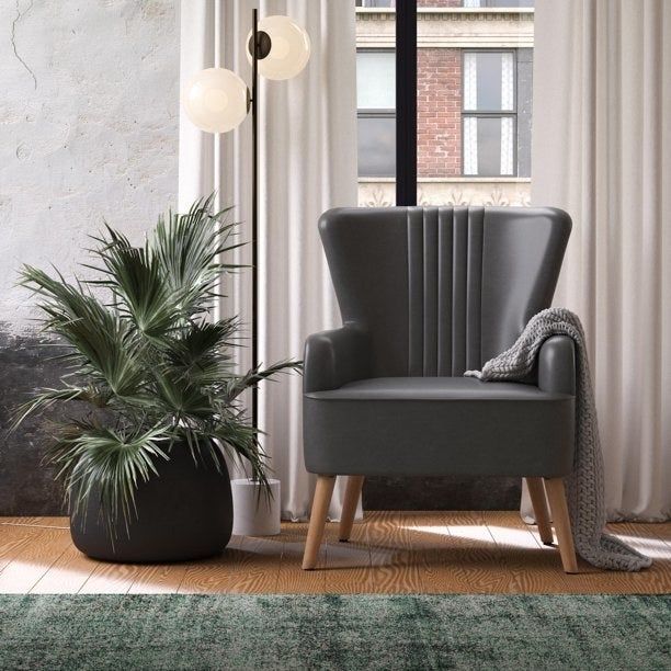 A reviewer image showing a stylish gray chair.