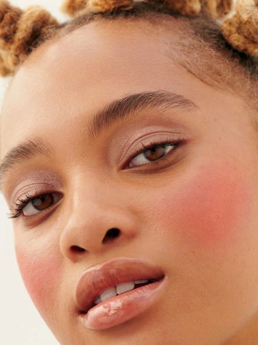 model wearing Glossier Cloud Paint in a soft pink hue