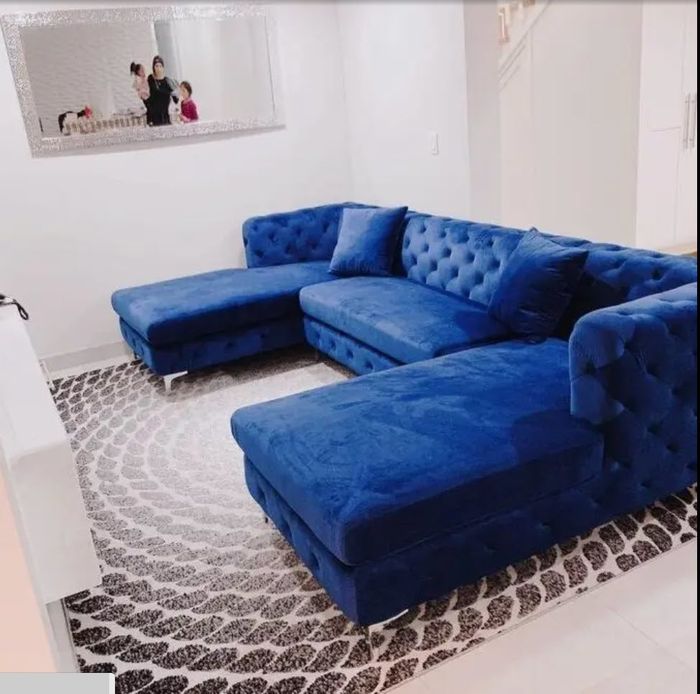 large royal blue tufted sectional couch with double chaise lounges for extra lounging space