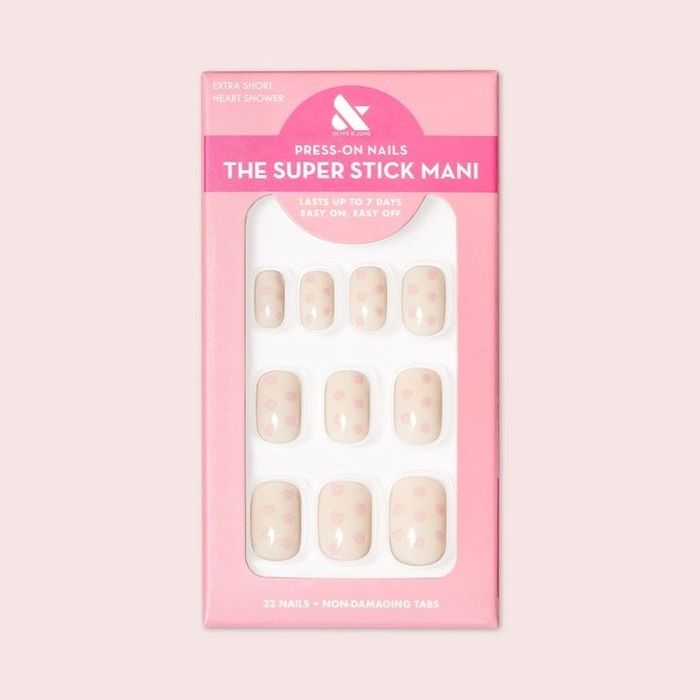 White press-on nails featuring delicate pink heart accents.