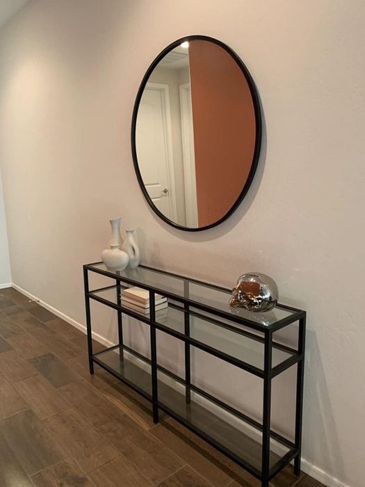 a black console table with decor pieces, reviewed by a customer