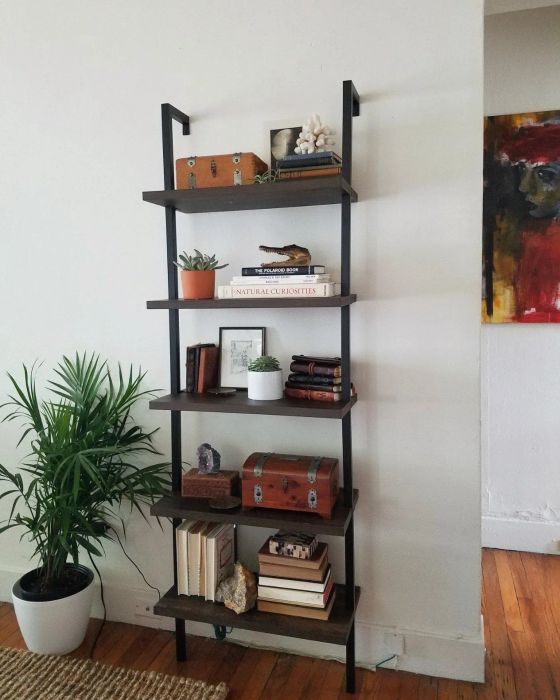 A reviewer's bookshelf in rich walnut and black tones