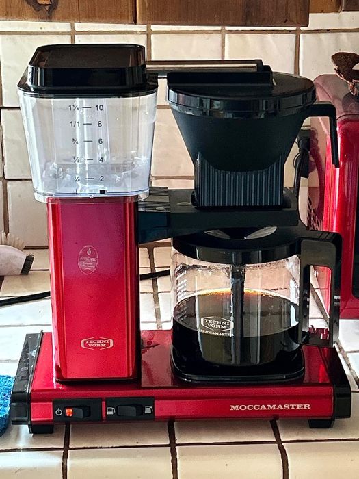 A red Moccamaster coffee machine.