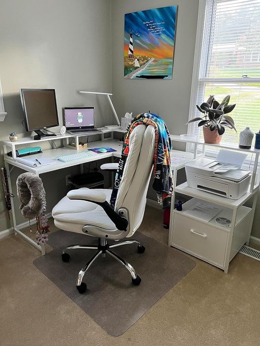 a reviewer's white corner desk