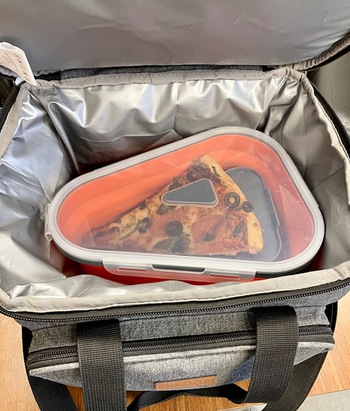Pizza slices neatly stacked inside the collapsible container.