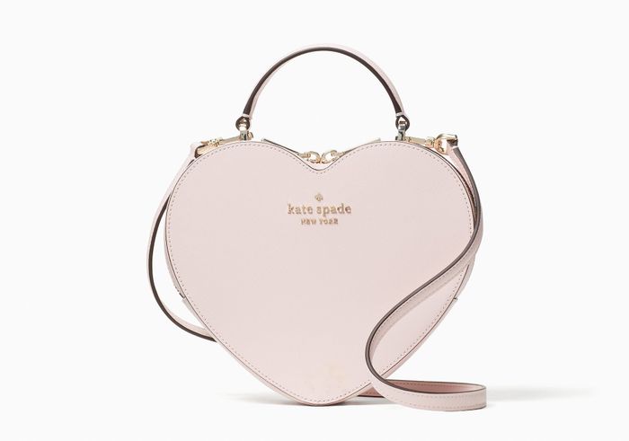 A light pink heart-shaped Kate Spade bag