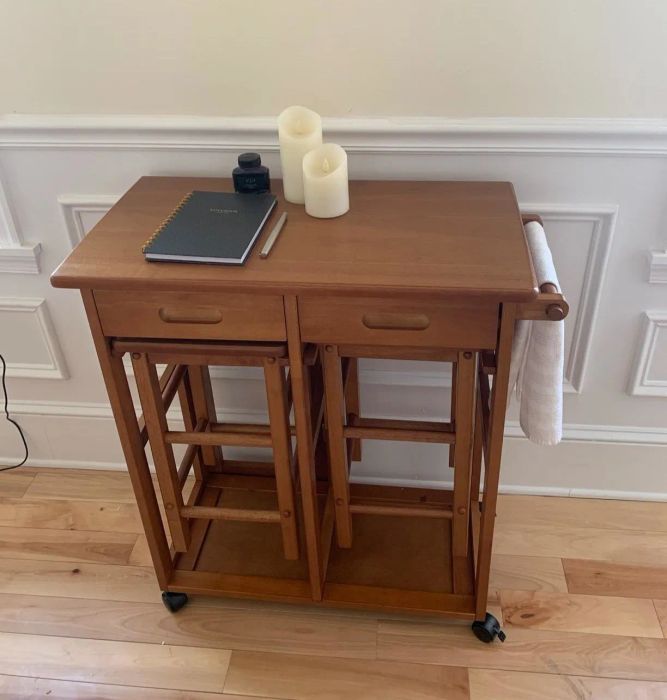 A reviewer showing the three-piece set stored compactly.